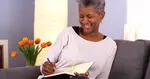 Black Woman writing in journal
