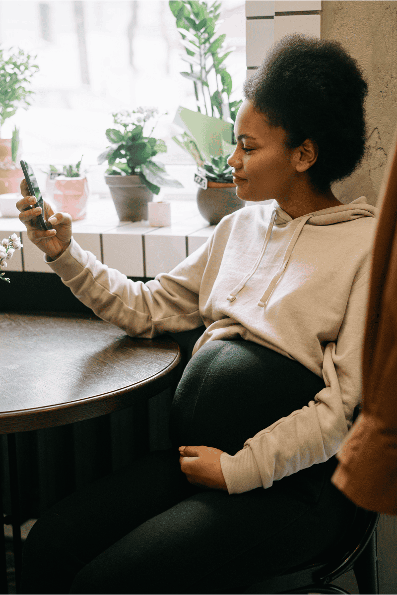 Pregnant Woman with Vision Board Cellphone